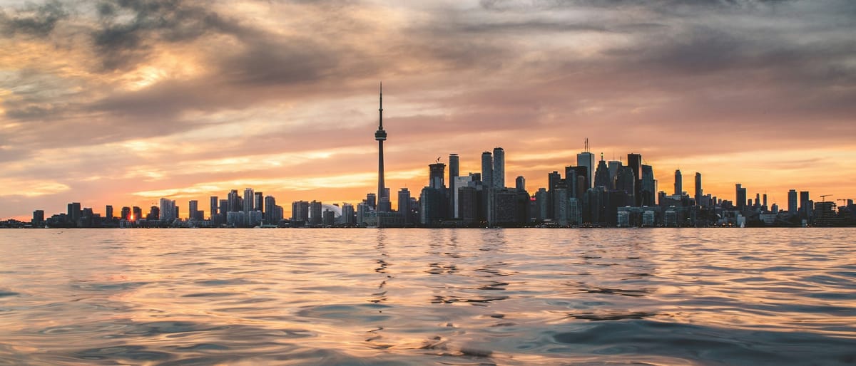 Toronto skyline and CN Tower at sunset, viewed across Lake Ontario